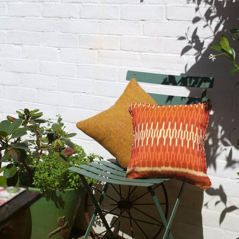 Harris Tweed and Ikat Cushions on a Patio Chair under the Sun