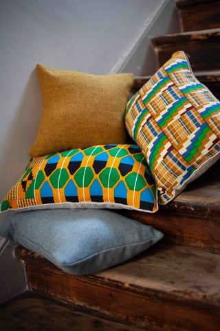 Harris Tweed and Kente Cushions in a  Wooden Staircase