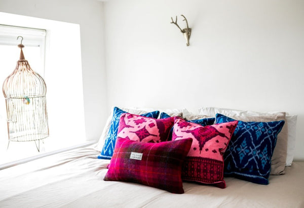 Ikat and Harris Tweed Cushions on a White Bed