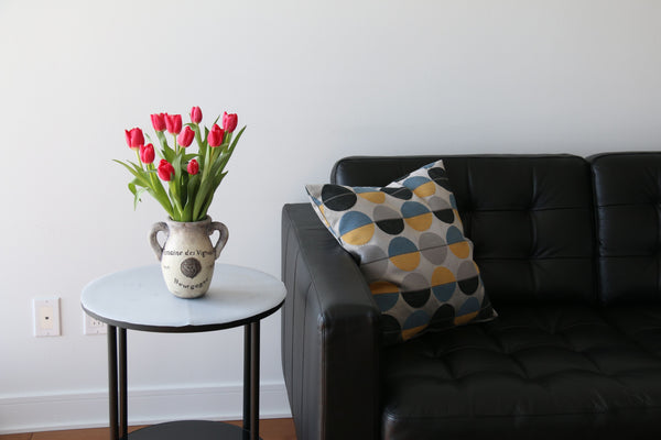 Patterned Cushion on a Black Leather Sofa