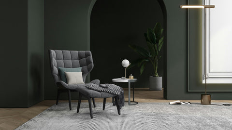 Modern living room, armchair, cushions in cream, olive green, grey rug