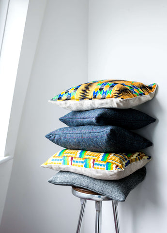 Stacked Harris Tweed and Kente Cushions In A Stool