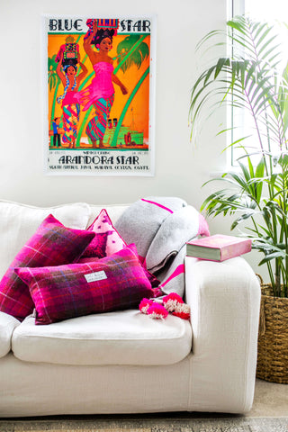 Pink Check Harris Tweed Cushion and Pink and Cerise Ikat Cushion on a White Sofa with book, grey throw and Arandora Star poster