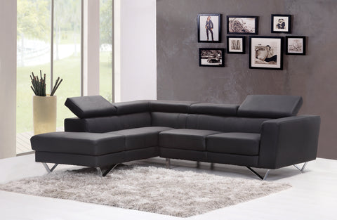 L-shaped black sofa in a living room with picture frames hanging in the background
