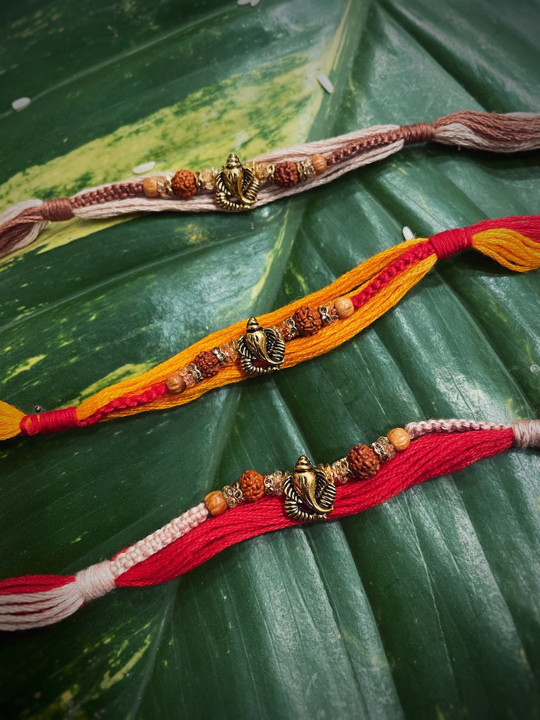 image for (COMBO of 3) Fancy Rakhi Designs Ganesh Ji Pendant/Rudhraksha Multicoloured Mauli Raksha Bandhan