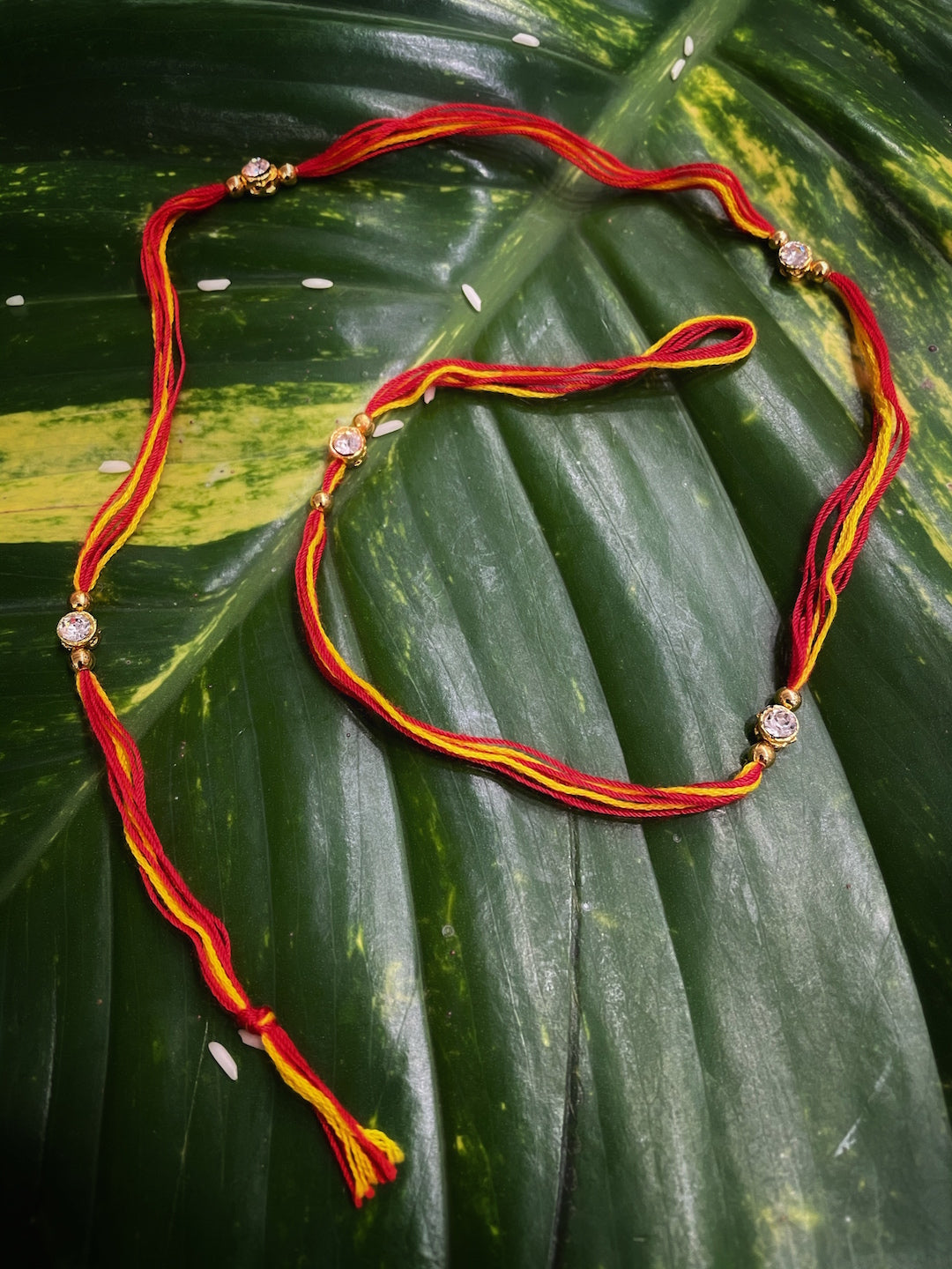 image for Simple Beautiful Diamond Studded On Red/Yellow Thread Mauli Rakhi For Raksha Bandhan