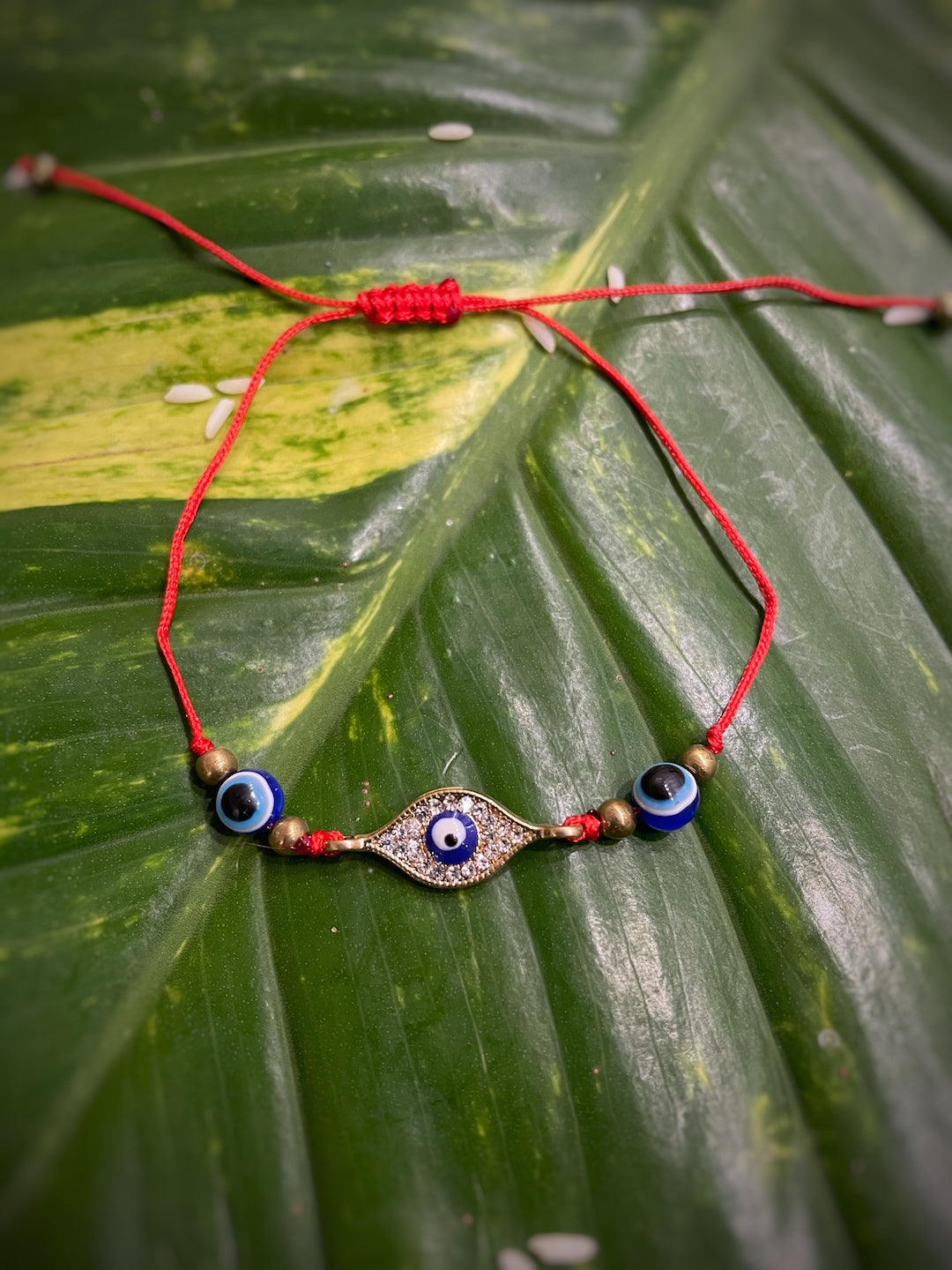 image for Beautiful an American diamond Studded Evil Eye Charm With Red Thread Designer Rakhi For Raksha Bandhan