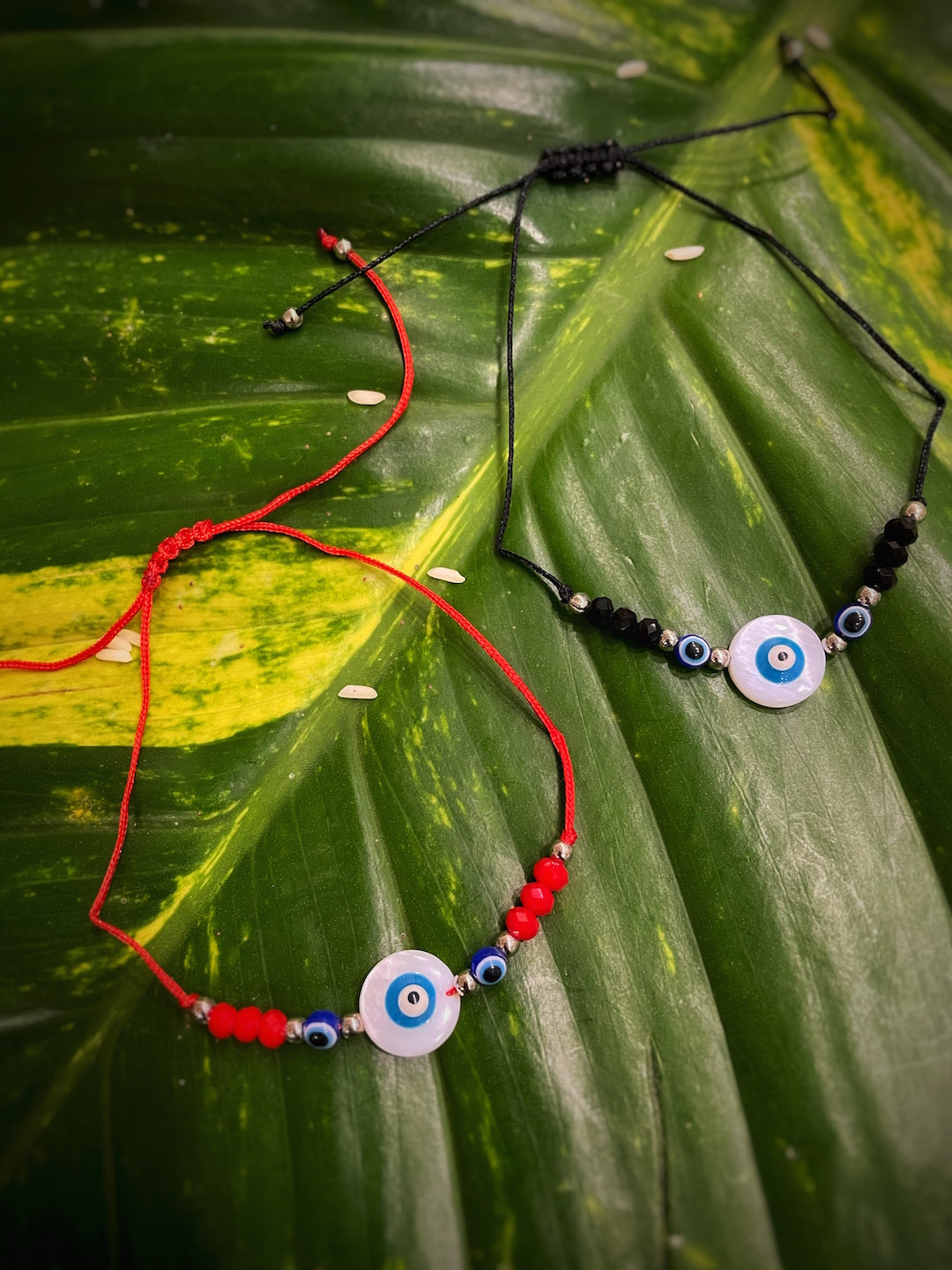 image for (Combo of 2) Fancy Rakhi Designs White Evil Eye Pendant with Red/Black Beads & Mauli Raksha Bandhan