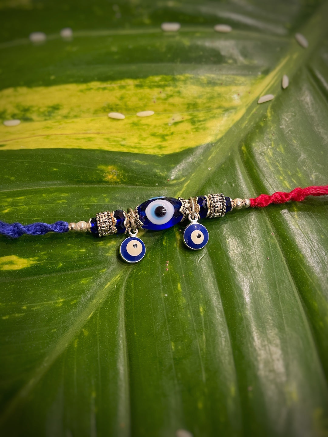 image for Designer Evil Eye Charm Rakhi Bracelet With Multicolored Thread Rakhi For Raksha Bandhan