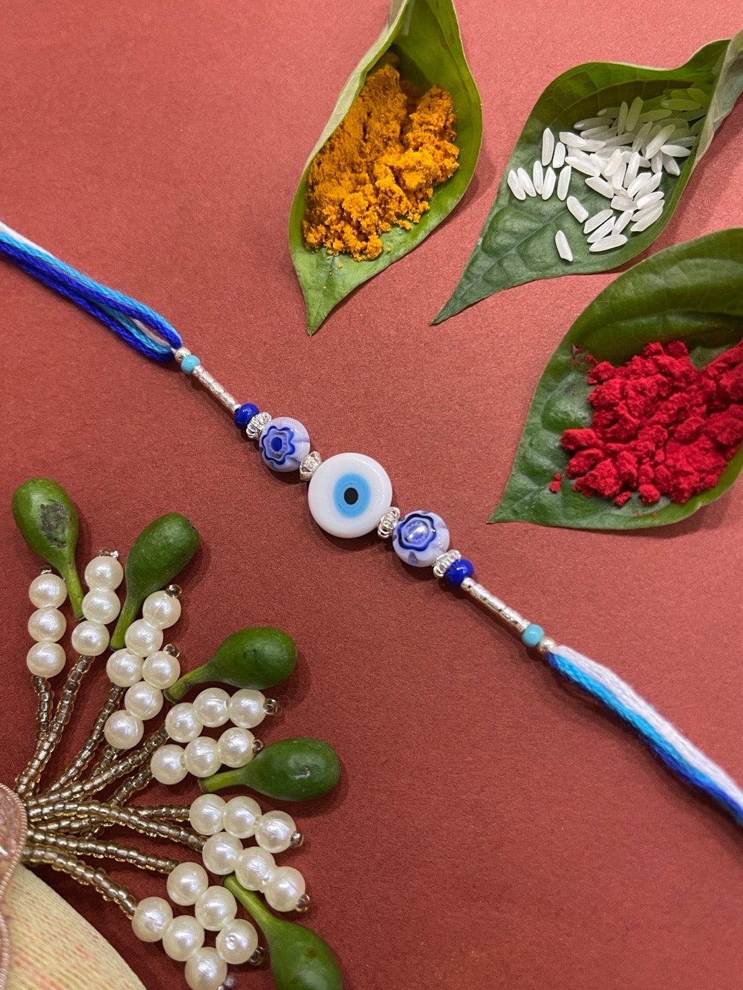 image for Fancy Designer Rakhi With White Evil Eye And Blue Beads Multicolor Thread Rakhi For Brother