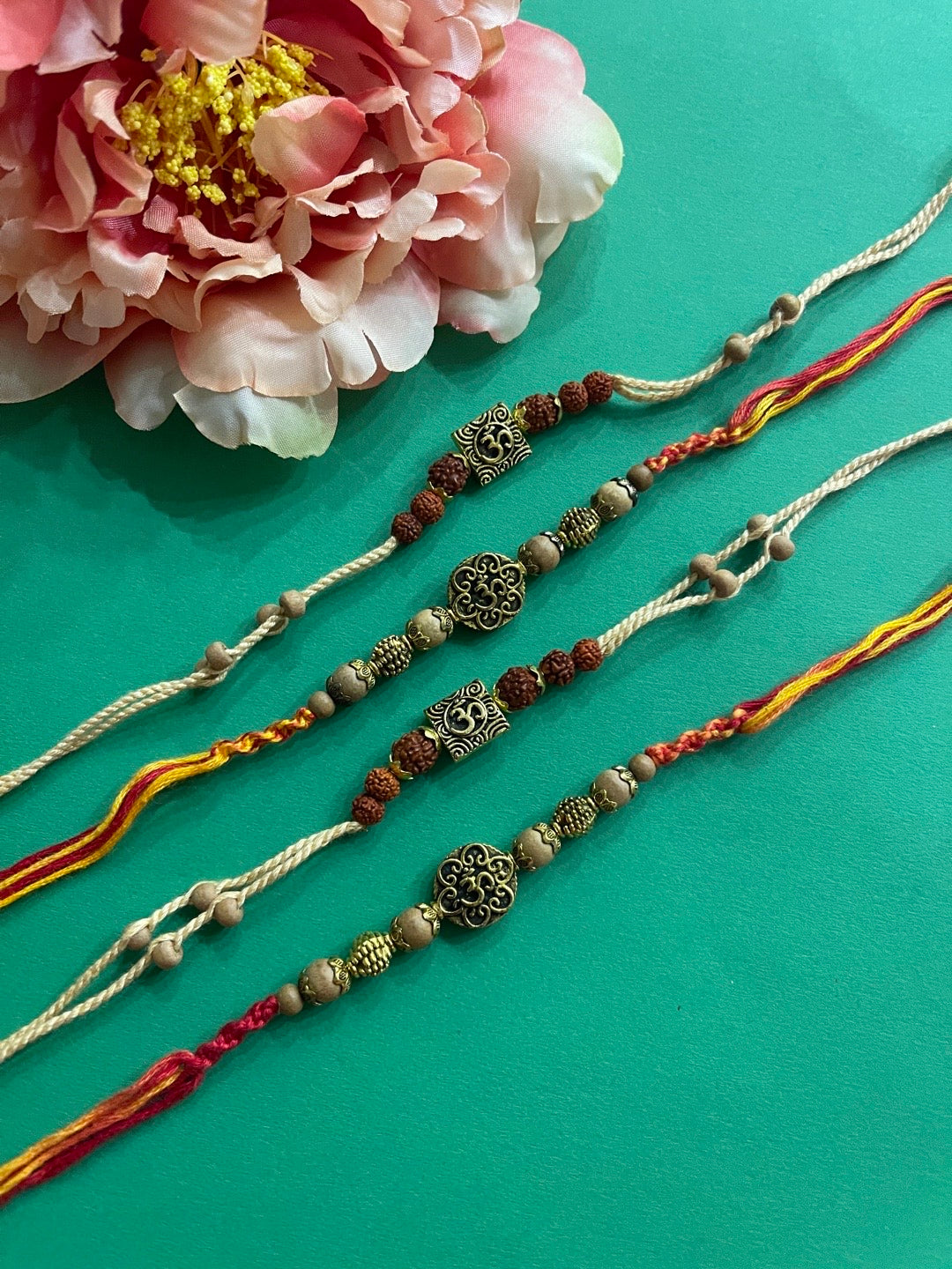 image for (Combo of 4) Unique Rudraksha & Chandan Beads Rakhi Om Designs With Multicolor Thread Rakhi