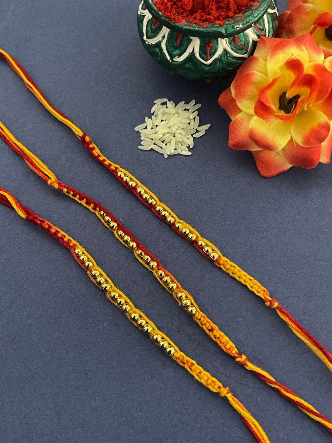 image for (Rakhi Set of 3) Simple Golden Beaded Rakhi Criss Cross Mauli Thread Rakhi For Raksha Bandhan
