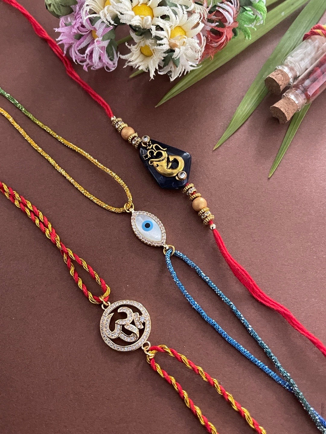 image for (Combo of 3) Lord Ganesha/American Diamond Om & Evil Eye Charm With Beads multicolour Thread Rakhi