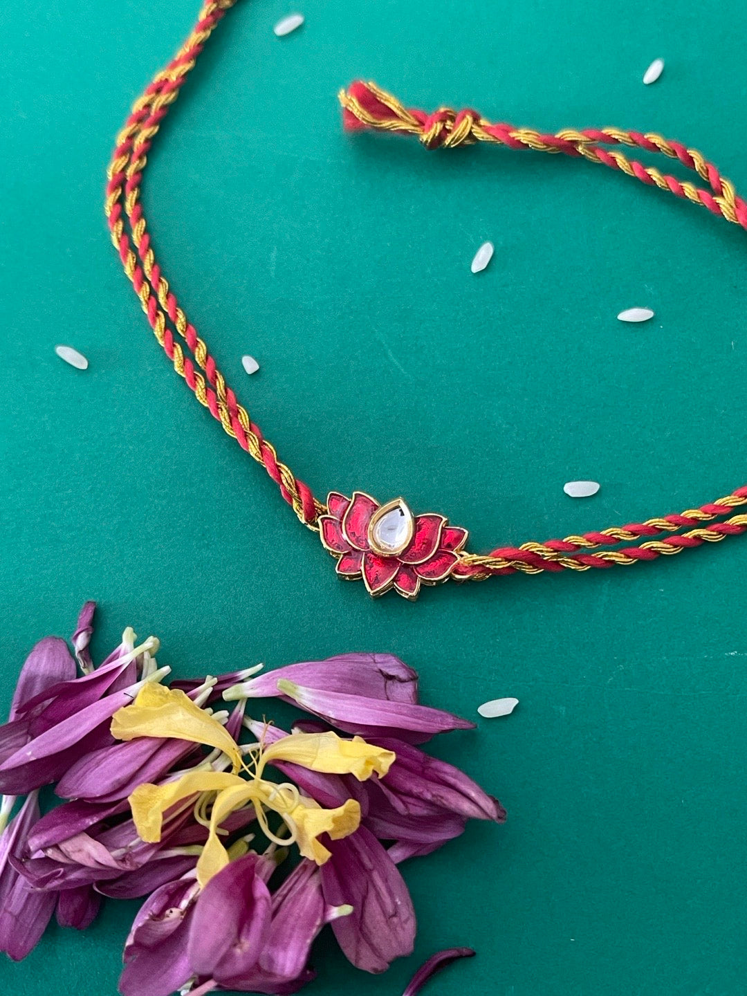 image for Simple Rakhi Thread With Red Lotus Flower Special Rakhi For Raksha Bandhan