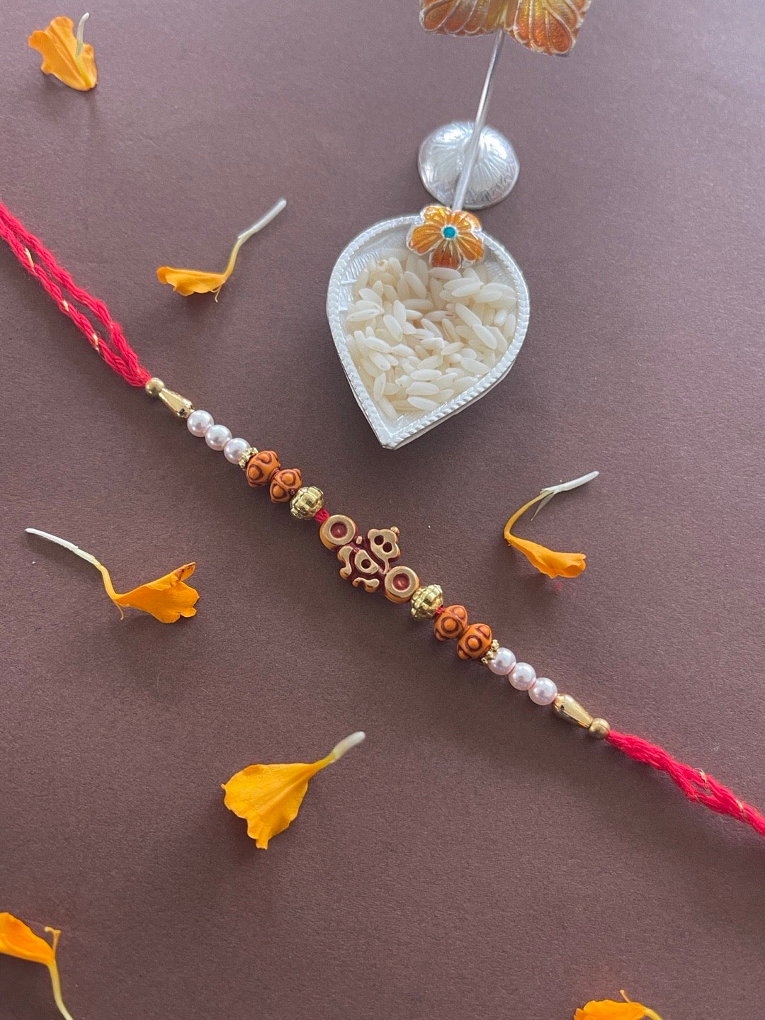 image for Simple Ganesh Rakhi With Beads And Moti Red Thread Rakhi For Raksha Bandhan
