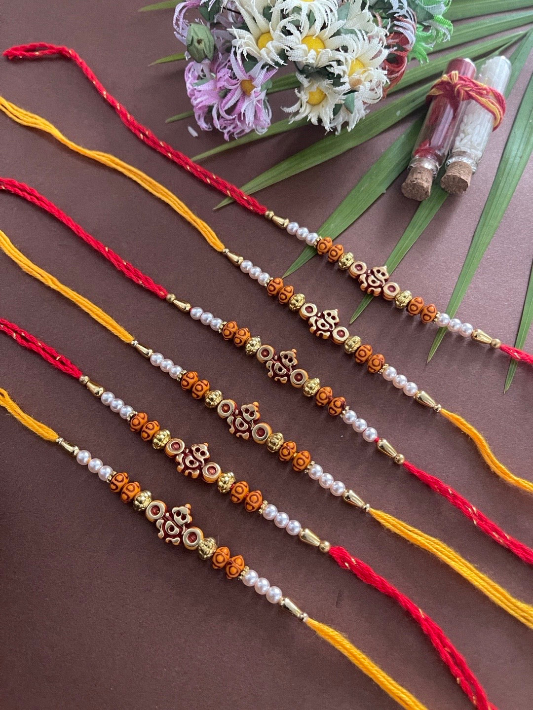 image for (Rakhi Set of 6) Simple Ganesh Rakhi With Beads And Moti Red/Orange Thread Rakhi For Raksha Bandhan