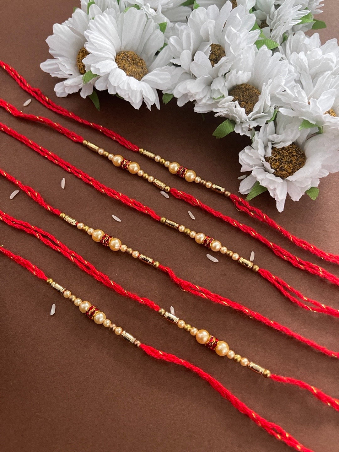 image for (Rakhi Set of 6) Beautiful Simple Pearl Rakhi With Beads Red Thread Rakhi For Raksha Bandhan