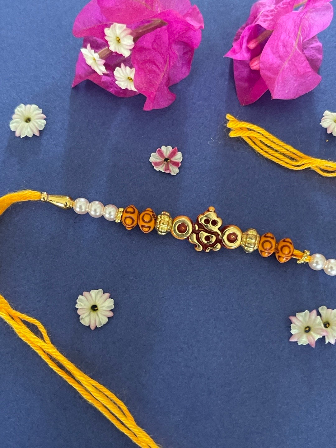 image for Simple Ganesha God Pearl Rakhi With Beads Orange Thread Rakhi Raksha Bandhan