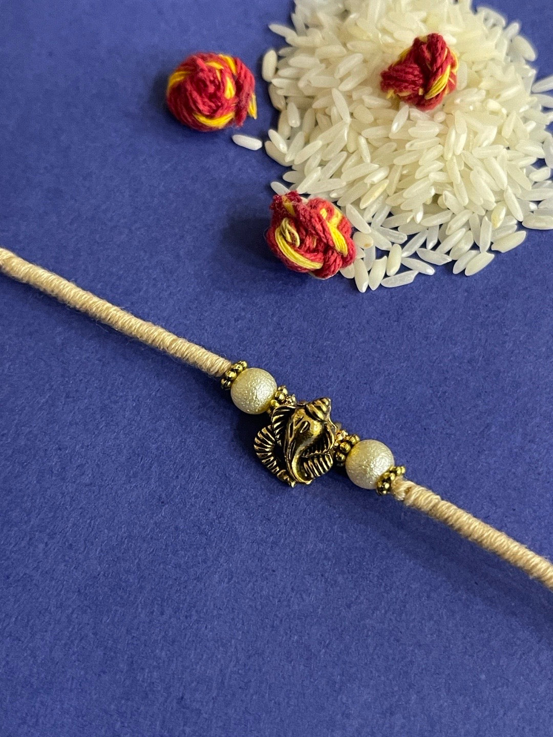 image for Designer Rakhi With Ganesha And Pearls Cream Color Thread Rakhi For Raksha Bandhan