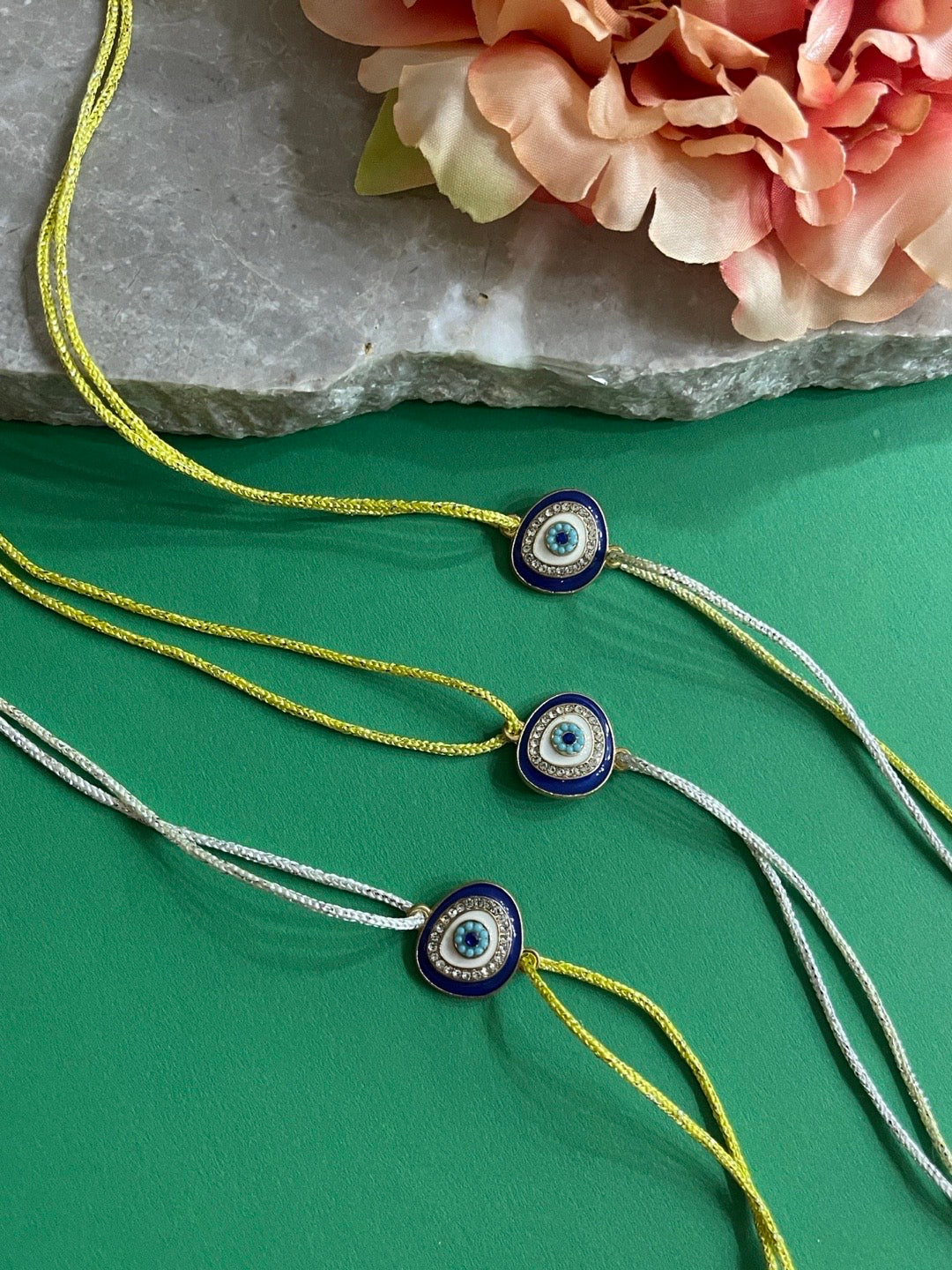 image for (Combo of 3) Beautiful Diamond Rakhi Evil Eye Charm With multicolour Thread Rakhi For Rakshabandhan