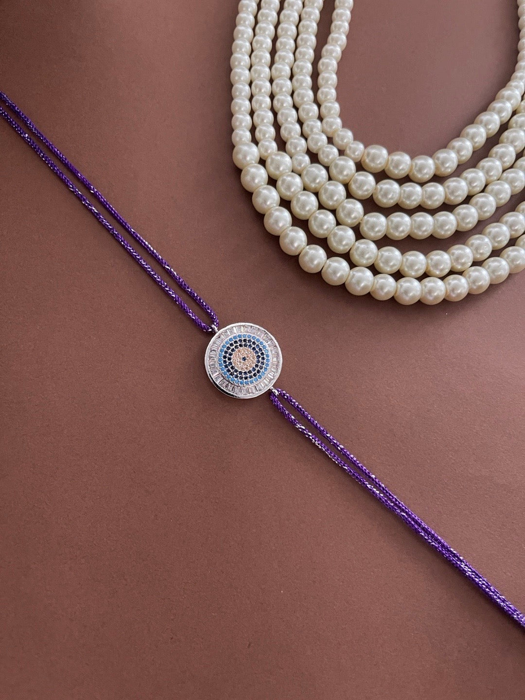 image for Latest American Diamond Round Evil Eye Rakhi With Purple Thread Rakhi For Rakshabandhan