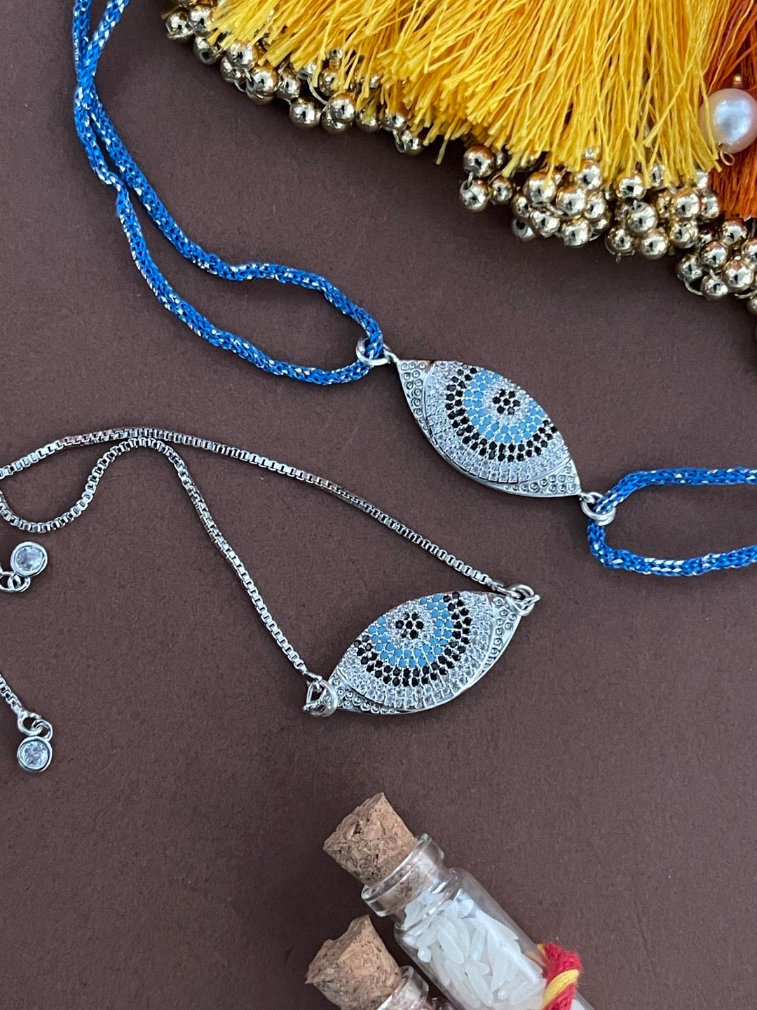 image for (Rakhi Set of 2) Silver Plated Diamond Evil Eye Charm Rakhi Thread & Bracelet For Brother-Bhabhi