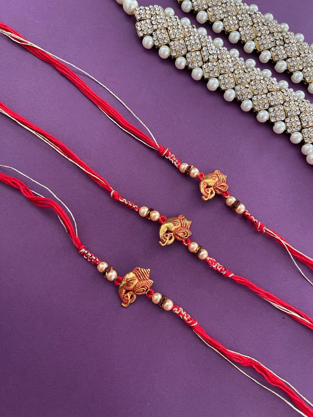 image for (Rakhi Set of 3) Latest Designer Ganesh Rakhi With Pearls Red Thread Rakhi For Rakshabandhan