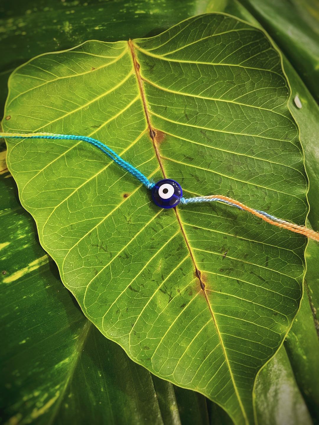 image for Simple Beautiful Designer Rakhi Evil Eye Charm With Multicolored Thread For Raksha Bandhan