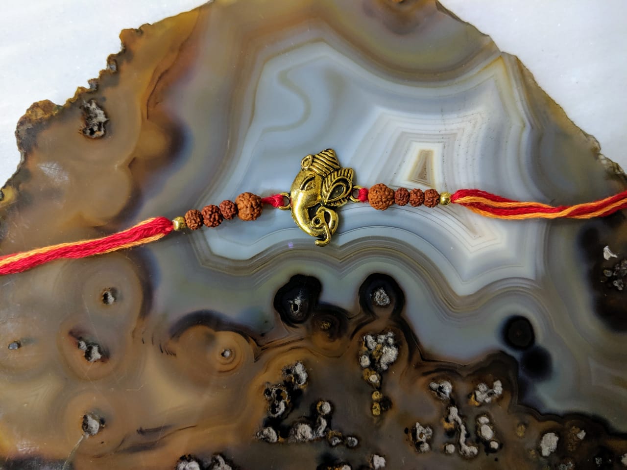 image for Ganesh Ji Rakhi for Men Gold Rudraksha Beads Multicolor Thread Rakhi