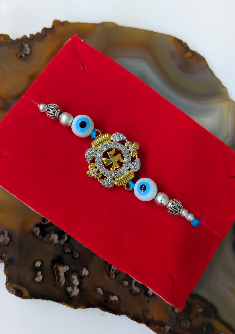image for Golden Rakhi With Swastik Design with Evil Eye Silver Beads Blue Thread Rakhi For Men