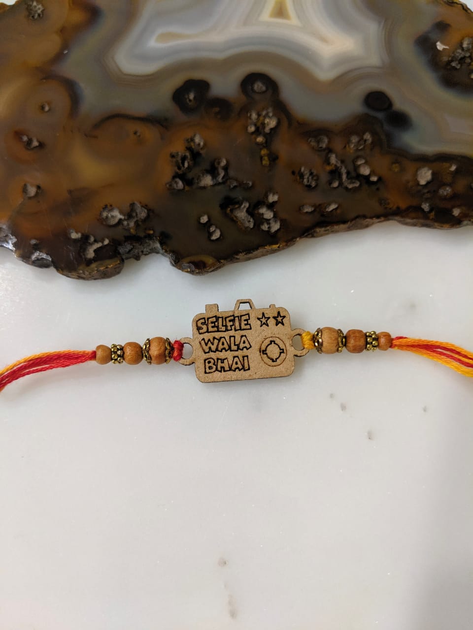 image for Wood Camera Designer Rakhi with Selfie Wala Bhai Slogan Beads Multicolor Thread Rakhi