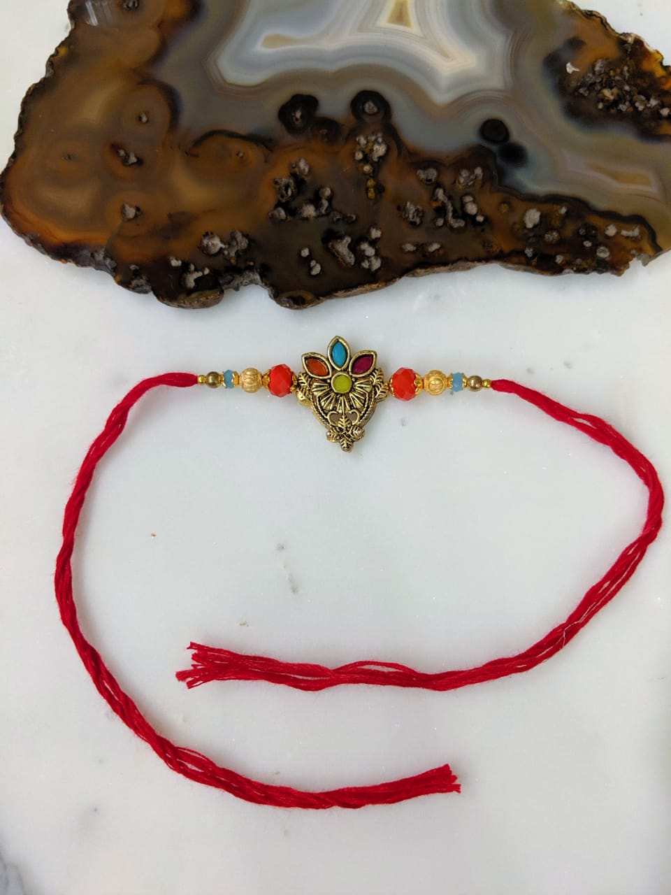 image for Gold Plated Rakhi With Flower Multicolor Gemstone Beads Red Thread Rakhi For Men