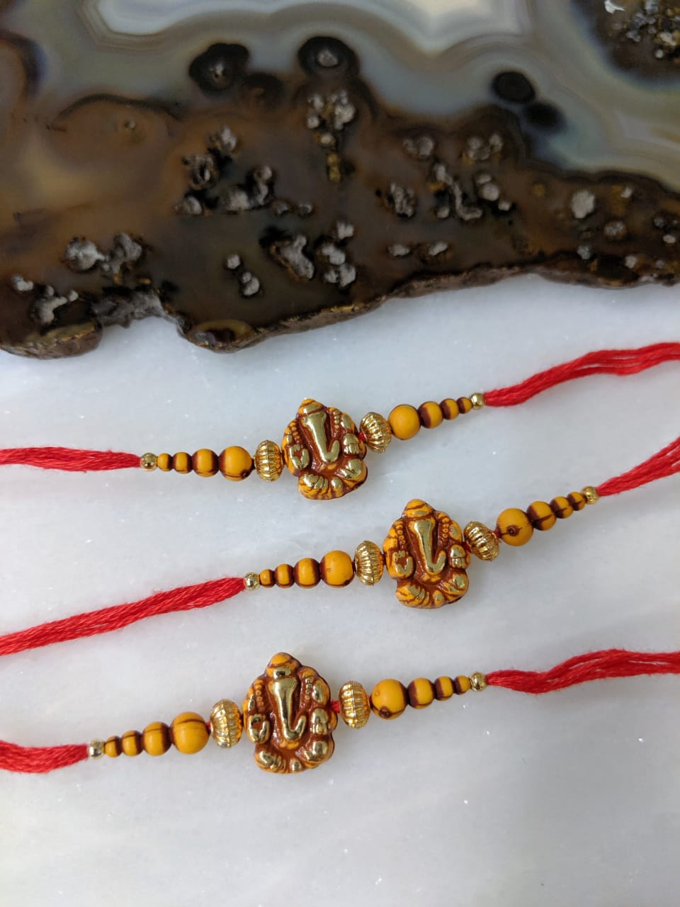 image for (Set of 3) Ganesh Ji Rakhi for Men Gold Yellow Beads Rakhi