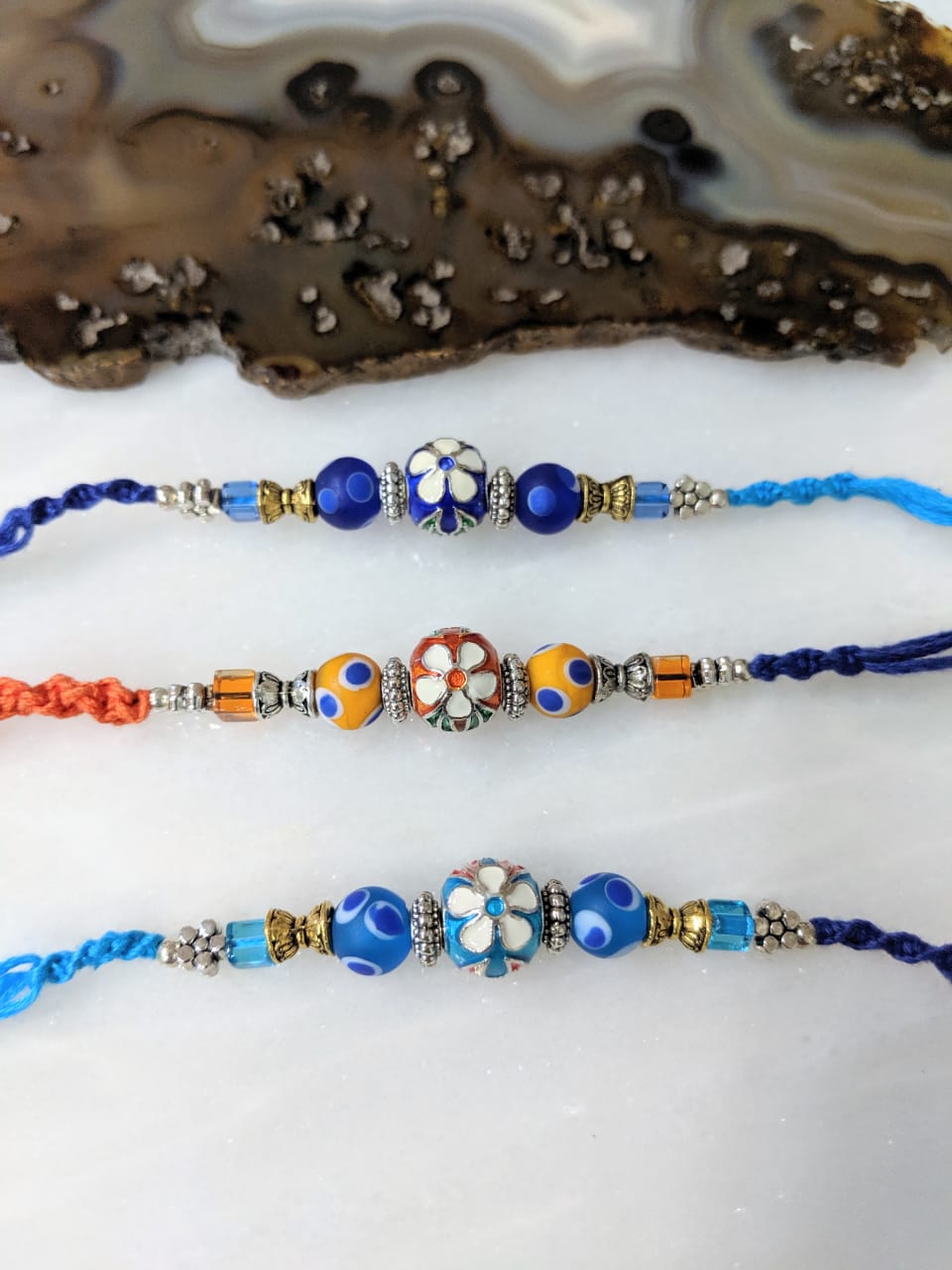 image for (Set of 3) Flower Rakhi for Men Blue Orange Beads Multicolor Thread Rakhi