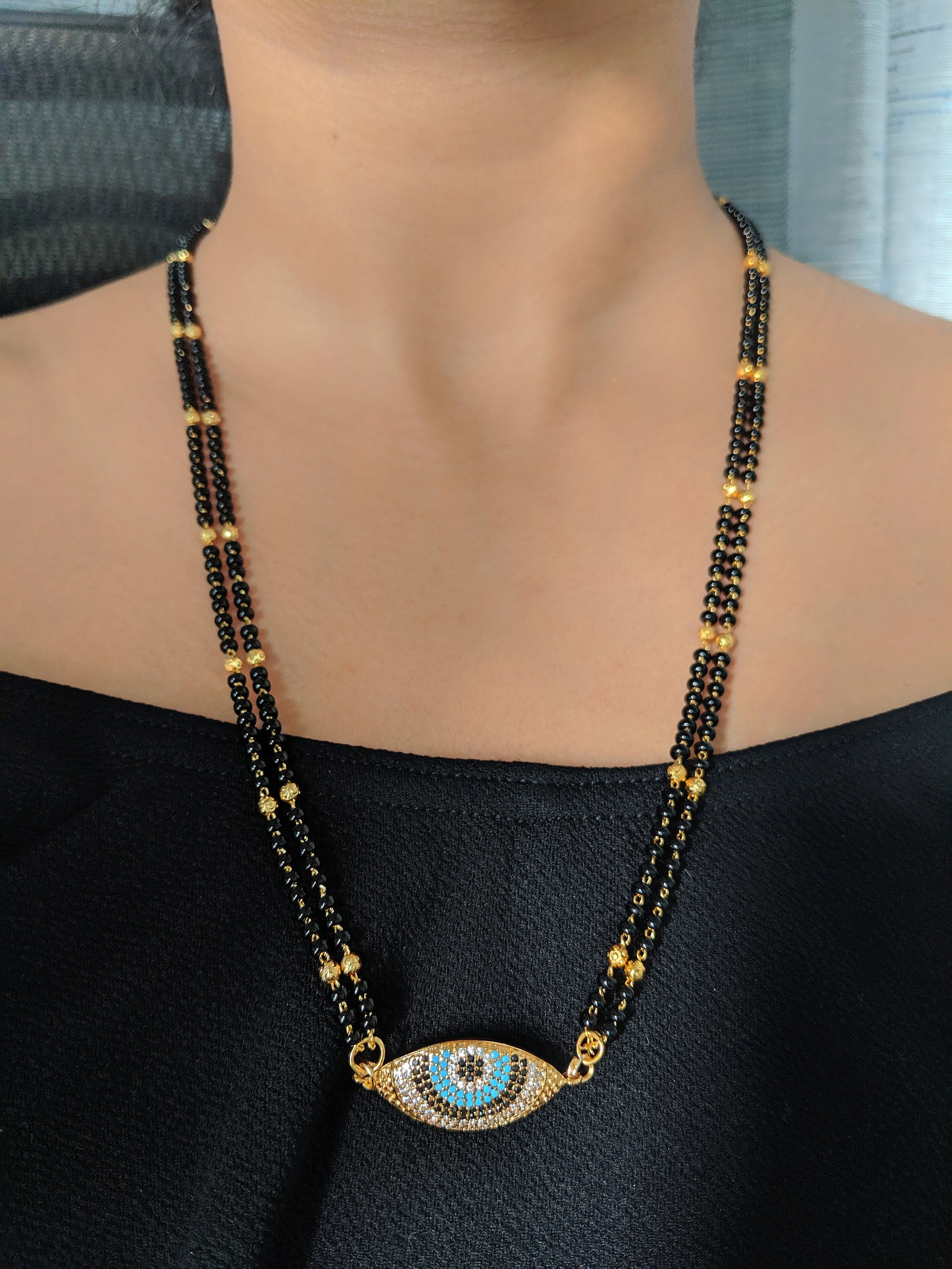 image for Modern Gold Short Mangalsutra Designs American Diamond Evil Eye Pendant Gold And Black Beads Chain