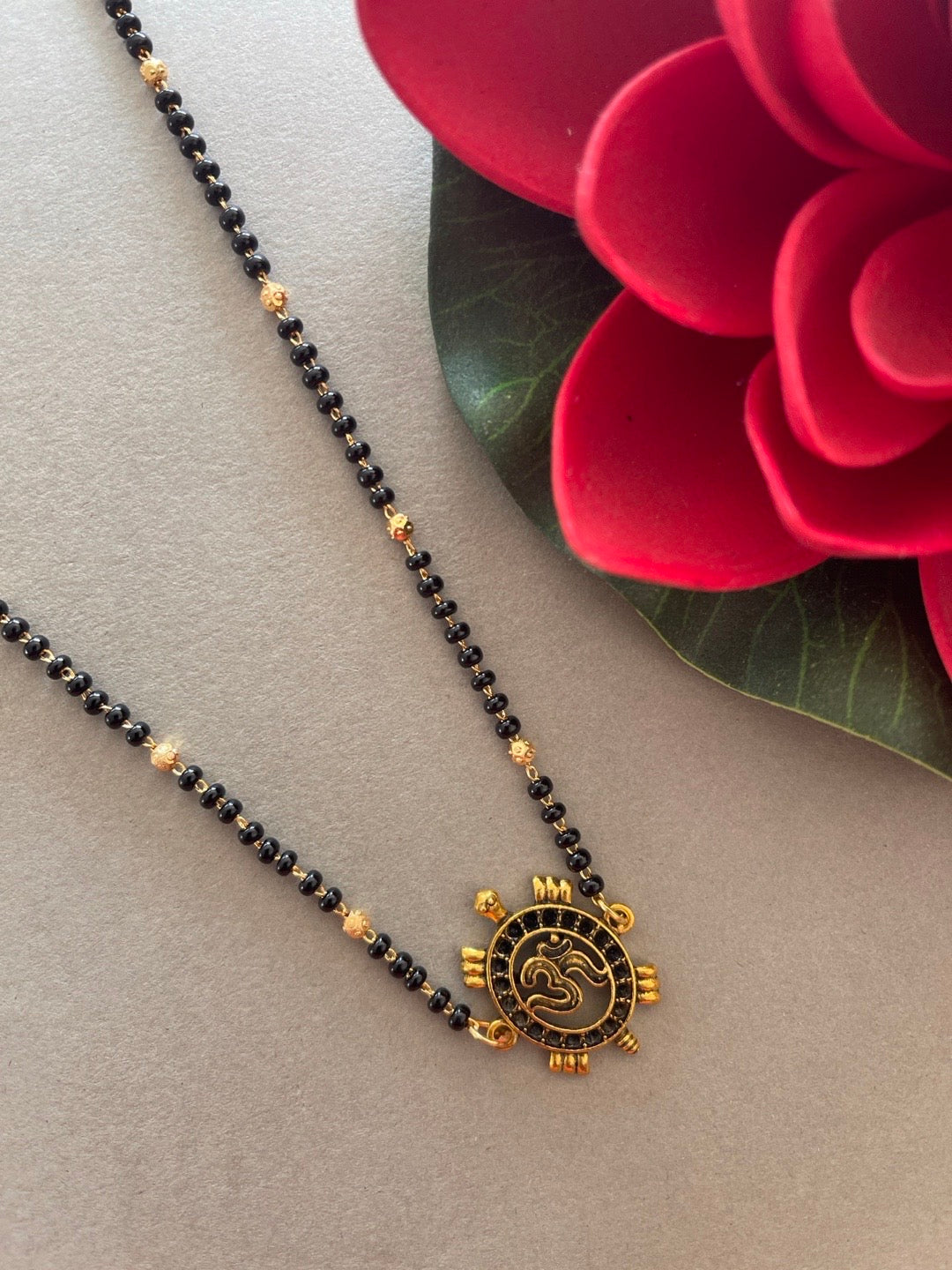 image for Simple Modern Short Mangalsutra Designs Gold Plated Tortoise/Om Pendant Gold And Black Beads Chain