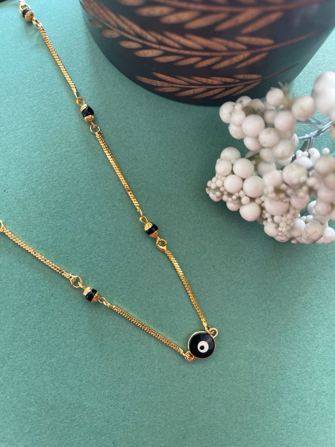 image for Gold Plated Fancy Short Mangalsutra Designs Evil Eye Round Pendant Black Beads Gold Chain