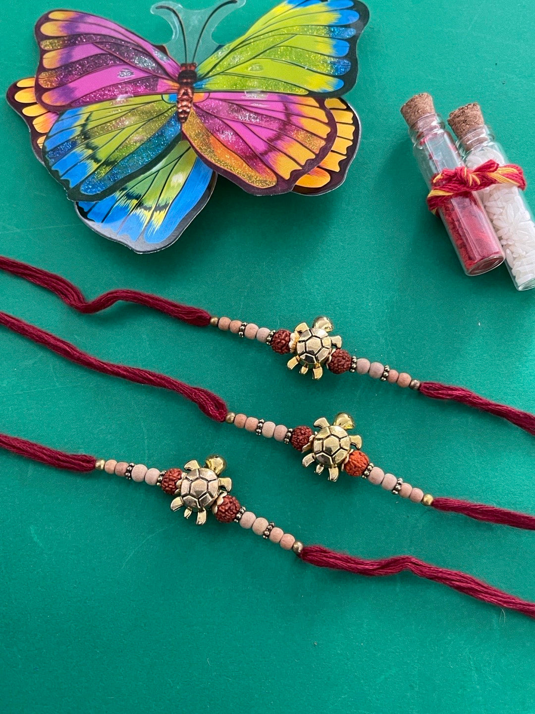 image for (Set of 3) Tortoise Designer Rakhi for Men Gold Plated Rudraksha Tulsi Beads Maroon Thread Rakhi