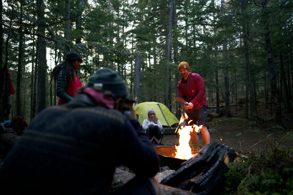 group gathering around a campfire