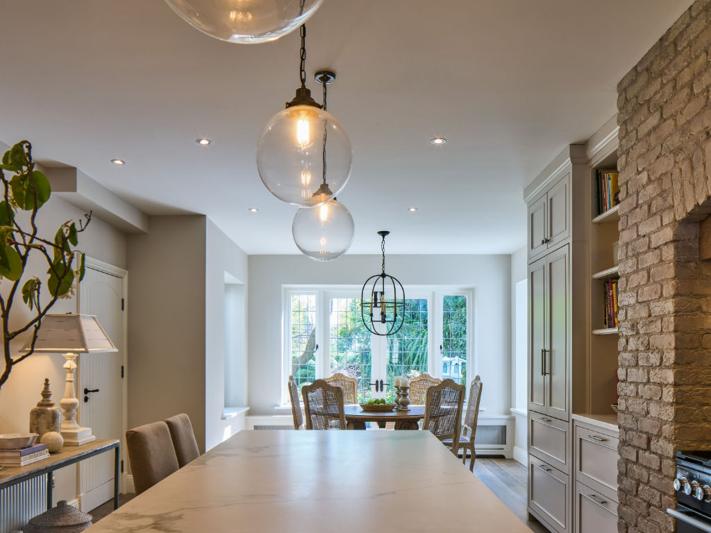 glass globe feature pendant lights above kitchen island