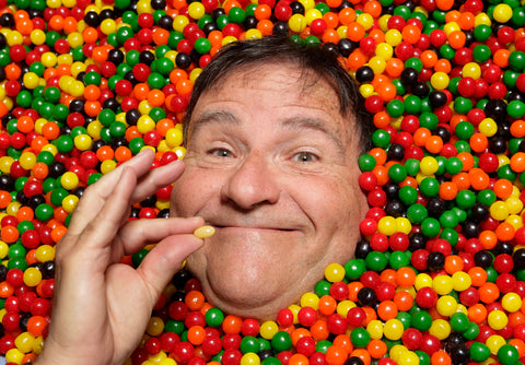 Jelly Belly founder sitting in tub of jelly beans