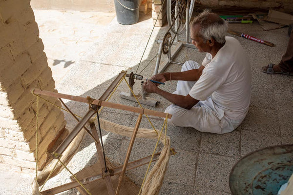 Man spinning wheel in Rajasthan