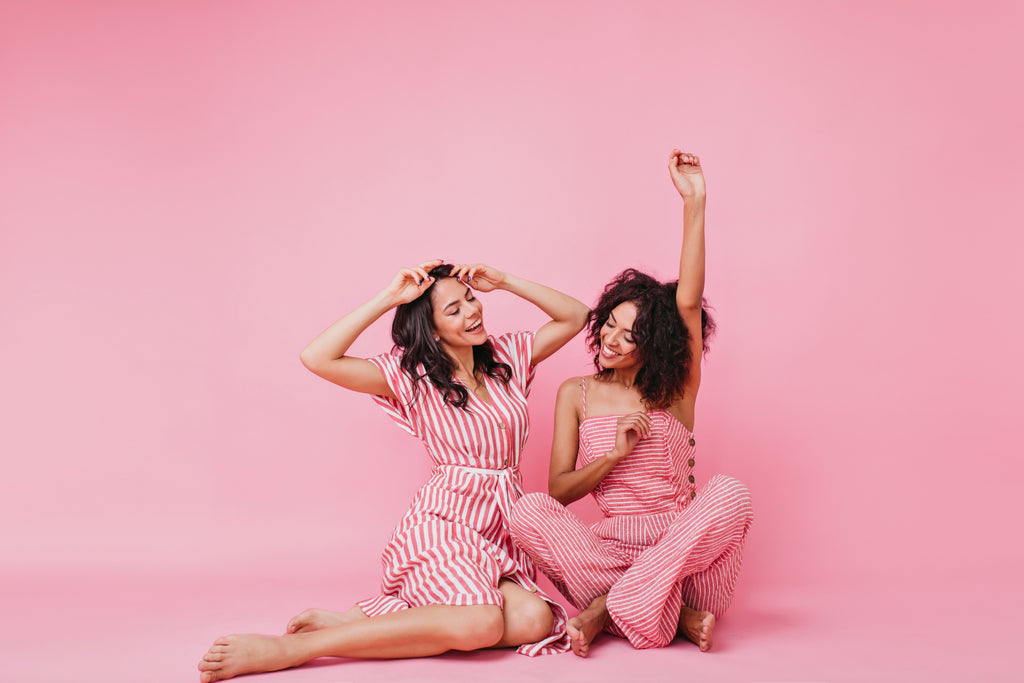 Two young women sat down, laughing 