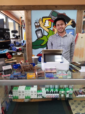 Matt Troetti behind the counter at Never Ever Boards