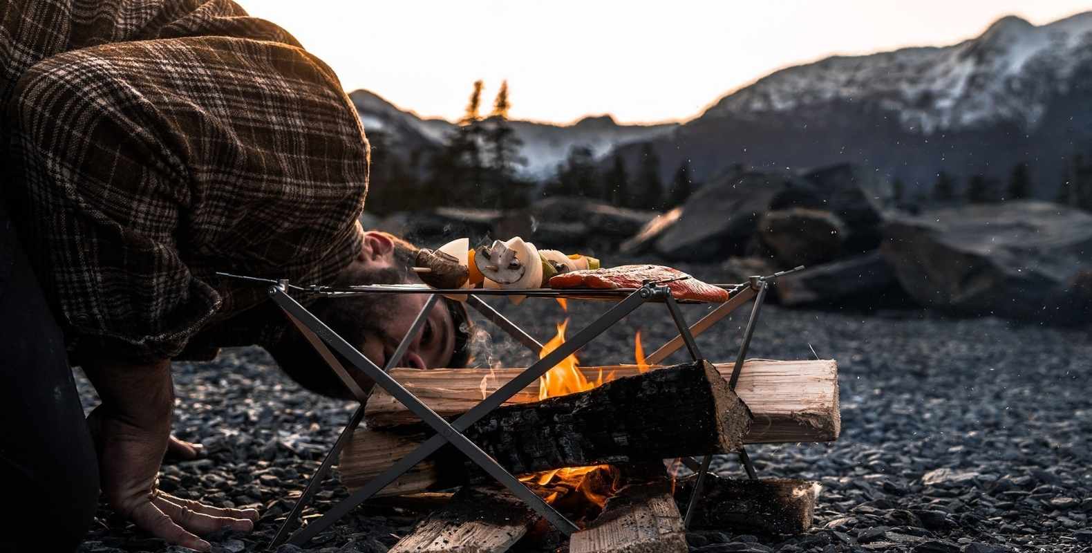 man cooking on wolf and grizzly grill