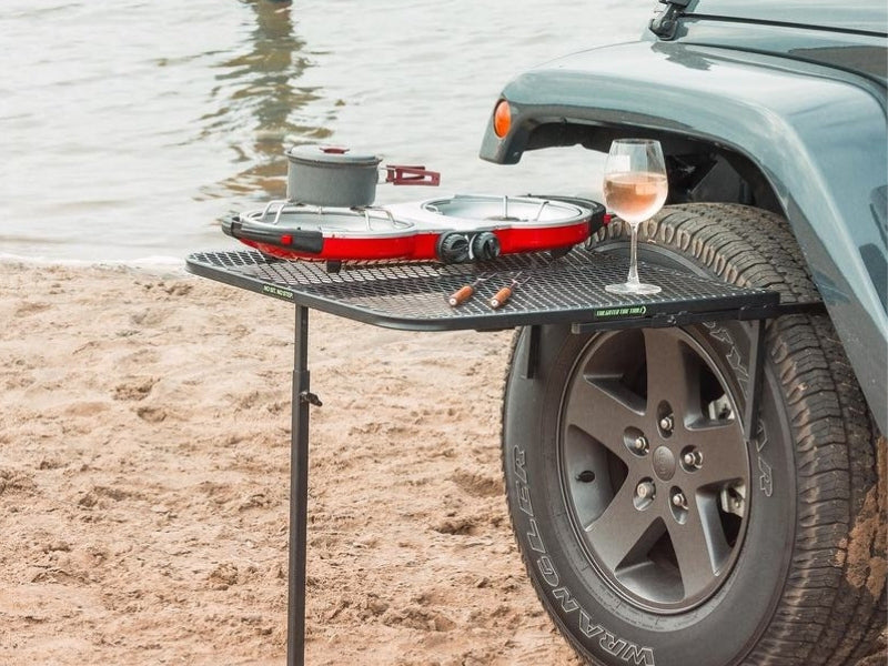tailgater table attached to a jeep on a beach