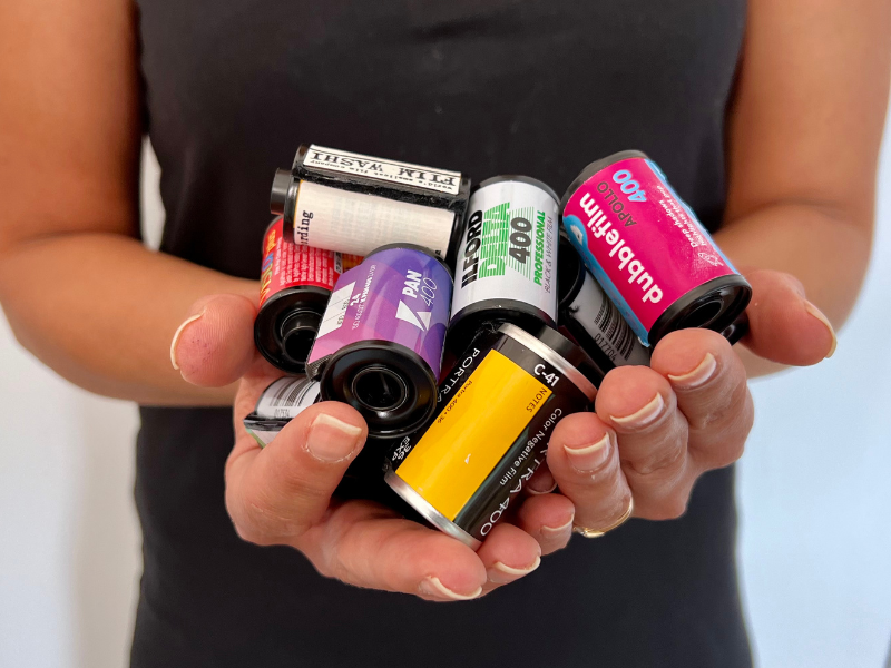 Why Shoot 35mm Film?| Handful of 35mm film canisters