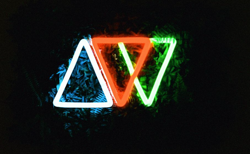 Analogue Wonderland logo shot on Harman Phoenix film - showing halation around the red neon