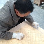 Smoothing the rattan panel on a Carved Coffee Table