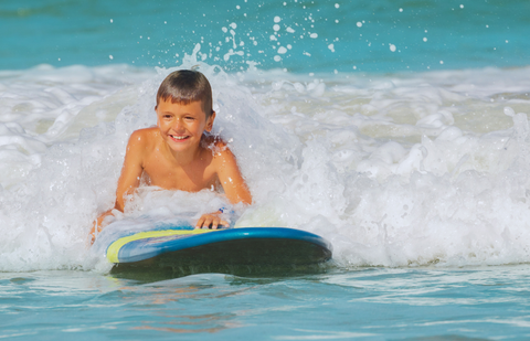 Young surfer on a foam surfboard.